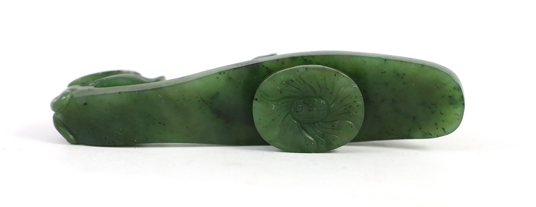 A Chinese bright spinach green jade ‘dragon’ belt hook, 18th/19th century, 9.5cm long